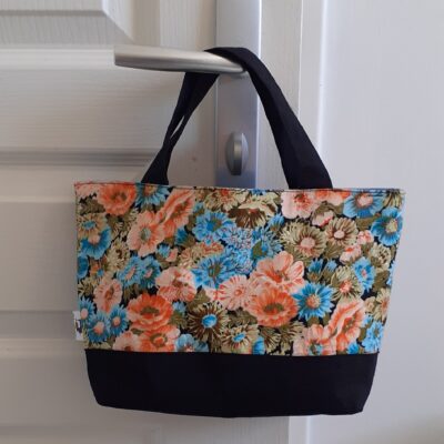 Sac Cabas rigide fond noir et partie supérieur fleuri orange bleu, anses noires